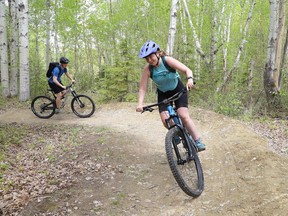 argot West, foreground, and Domenic St-Aubin cycle through the bush at the Walden Trails in Naughton on Friday. John Lappa/Sudbury Star
