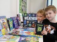 Gordon Joanette, right, and Adrick Leroux, both 6, check over the selection of books at a spring week-long book fair at Chelmsford Valley District Composite School on Tuesday The book fair is part of activities being held for Education Week at Rainbow schools. John Lappa/Sudbury Star