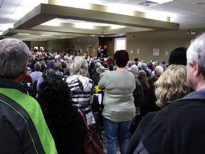 It's standing-room only at the Save the Durham Hospital rally inside the Durham Community Hall on Tuesday, May 8, 2024, as Save the Durham Hospital committee chair Jana White readies to begin the evening of speakers on stage. Greg Cowan/The Sun Times