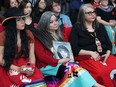 Gerri-Lee Pangman (centre) holds a picture of sister Jennifer McPherson, who was murdered in 2013, during the announcement of a Missing and Murdered Indigenous Women and Girls and Two-Spirited Peoples endowment fund, at the Canadian Museum for Human Rights in Winnipeg, on Sunday, May 5, 2024.