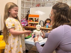 Isla Gerster, 4, and Bailey Felker, a child-life specialist, role play to prepare for a vaccine appointment at London Health Sciences Centre's new pediatric vaccination clinic. Photo taken on Tuesday, June 18, 2024. (Beatriz Baleeiro/The London Free Press)