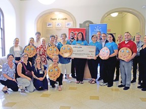 Kingston-area Tim Hortons staff and health-care workers with Kingston Health Sciences Centre assembled for a photo on Wednesday to mark this year's smile cookie campaign, which saw $177,413 donated to KHSC for its child and youth mental health services programs.