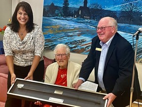 Annie May Simpson, centre, accepts the Kiwanis Club of Fredericton's Silver-Headed Cane Award for being the city's oldest resident from club president Anne Ruff, left, and past-president Mike Ross, right.