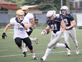 Luke Crepeau (21) of the Sudbury Spartans carries the football while Jake Skrinda (4) of the Tri-City Outlaws gives chase during Ontario Power 5 Football League action at James Jerome Sports Complex in Sudbury, Ontario on Saturday, June 22, 2024.
