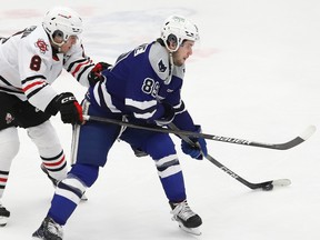 Nathan Villeneuve, right, of the Sudbury Wolves, attempts to evade Alex Assadourian, of the Niagara IceDogs, during OHL action at the Sudbury Community Arena in Sudbury, Ont. on Friday February 9, 2024.
