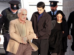 Three members of the Shafia family — Mohammad Shafia, from left, Tooba Mohammad Yahya and their son Hamed — enter Frontenac County Court House in Kingston on Jan. 16, 2012, for their murder trial. They were each charged with four counts of first-degree murder in the deaths of four other family members. IAN MACALPINE/KINGSTON WHIG-STANDARD/QMI AGENCY