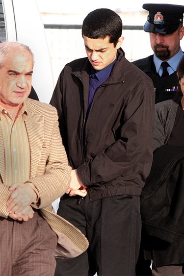Three members of the Shafia family — Mohammad Shafia, from left, Tooba Mohammad Yahya and their son Hamed — enter Frontenac County Court House in Kingston on Jan. 16, 2012, for their murder trial. They were each charged with four counts of first-degree murder in the deaths of four other family members. IAN MACALPINE/KINGSTON WHIG-STANDARD/QMI AGENCY