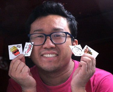 Jacky Leung, of The Tragically Chip, holds stickers he shares with customers at Poutine Feast at Downtown Plaza in Sault Ste. Marie, Ont., on Friday, June 28, 2024. (BRIAN KELLY/THE SAULT STAR/POSTMEDIA NETWORK)