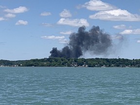Black smoke rises over Port Stanley after fire struck three boats at a marina on Saturday June 15, 2024. (Mike Hensen/The London Free Press)