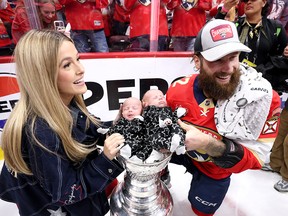 Jonah Gadjovich No. 12 of the Florida Panthers poses with the Stanley Cup his wife, Allison, and two children, Lion and Adalee, after Florida's 2-1 victory against the Edmonton Oilers in Game Seven of the 2024 Stanley Cup Final at Amerant Bank Arena on June 24, 2024 in Sunrise, Florida. (Photo by Bruce Bennett/Getty Images)
