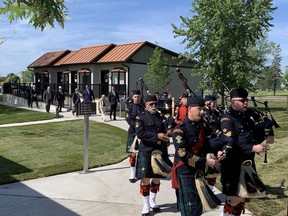 A pipe band leads in delegates to the grand opening of Homes for Heroes Village in Kingston on Tuesday.