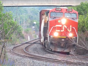 A CN freight train rolls under the Bayridge Drive overpass in Kingston, Ont.