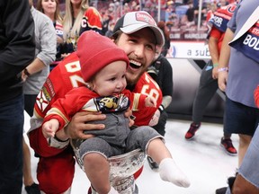 Brandon Montour of the Florida Panthers celebrates with his son, Kai, after Florida's 2-1 victory against the Edmonton Oilers in Game 7 of the 2024 Stanley Cup final at Amerant Bank Arena on June 24, 2024, in Sunrise, Fla. (Bruce Bennett/Getty Images)