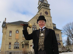 Les Whiting, Petrolia's town crier, stands in front of Victoria Hall in Petrolia.