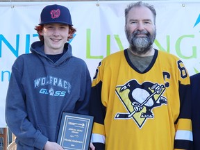 Nicolai Anderson, left, recently received this year's Community Living Sarnia-Lambton Hero Award for volunteering to teach Gene Davidson, right, how to play hockey.