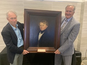 Ian Muirhead of Vancouver presents a portrait of his great, great grandfather William Muirhead, the first Mayor of Brantford, to Mayor Kevin Davis during a recent visit to the city. The portrait will be displayed in city hall. VINCENT BALL/Brantford Expositor