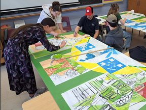 Low German Mennonite students at East Elgin secondary school in Aylmer work on a mural that depicts their culture's history.  (Submitted photo)