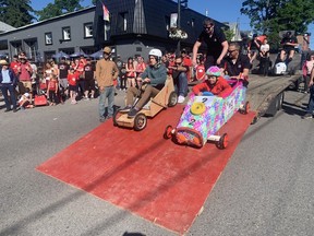 On Your Mark: Wyatt Gedye (left) and Zack McConnell, get ready to race down the Main Street in front of the Arbor Restaurant for the annual Kinsmen Soap Box Derby. They were helped out at the start by Nathan Hercanuck (left), Jake Patterson and Scotty MacDonald, of the Kinsmen Club of Port Dover. Vincent Ball