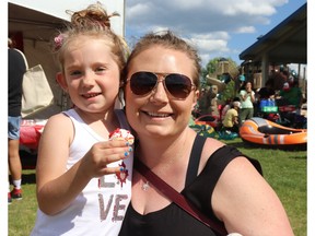 Brenna, left, and Mila Flynn of Whitecourt grabbed a free cupcake during Canada Day