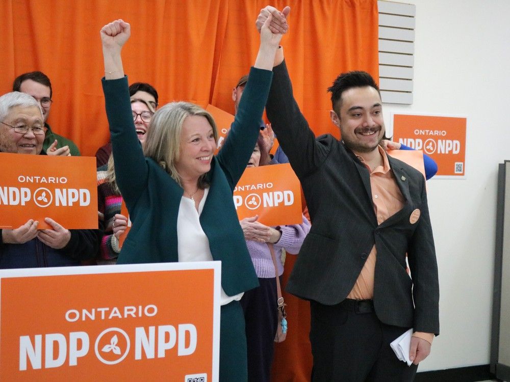NDP leader Marit Stiles and Kingston and The Island candidate Elliot Goodell Ugalde stand in front of supportors on February 4, 2025.