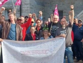 A groupf CUPE members standng outside Queen's University.
