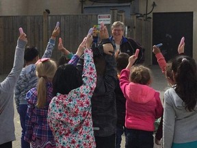School board trustee with some students