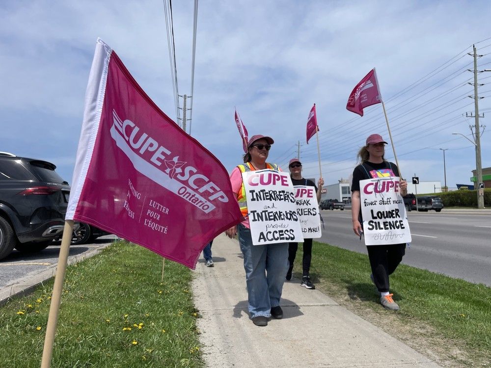 striking cupe workers walk a picket line in front of the canadian hearing society office in kingston, ont. on tuesday, may 13, 2025. (elliot ferguson/the whig-standard/postmedia network)