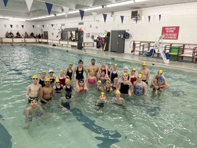 Canadian record holder Javier Acevedo, centre back row, celebrates a swim clinic with local SLSC 12 and under swimmers