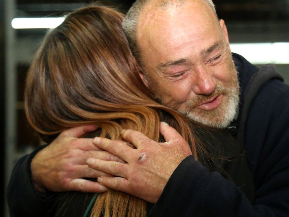 Guest Jeffery Scott Baldwin hugs the John Howard Society's lead adult service worker, Jasmine Gareau, Friday at The Bridge Integrated Care Hub in Belleville. The facility's director, Ashley Vader, say those who approach homelessness-related issues in a compassionate way are more likely to succeed.