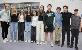 St. Michael's school teacher Kelli Houle, left, poses with Grade 7 and 8 students in two teams from the school at the One Future Enactus Lambton finals, at Lambton College May 22, 2025.