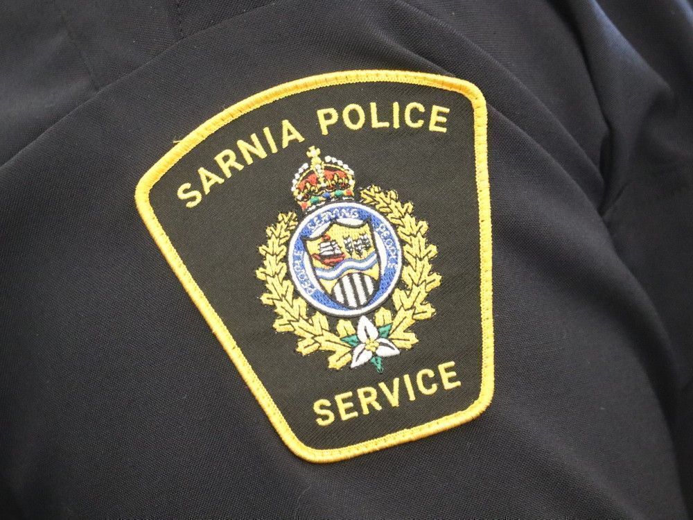 A man reported to be holding a knife and exposing himself outside a Sarnia variety store Saturday was arrested, says city police.