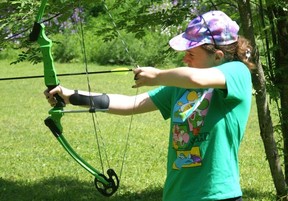 Evelyn Weirmeir aims a bow and arrow