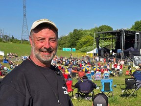man smiles in front of festival crowd