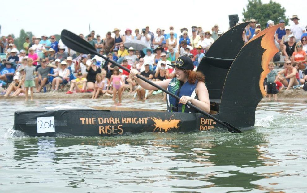 Grace Rooyakkers paddles her cardboard boat
