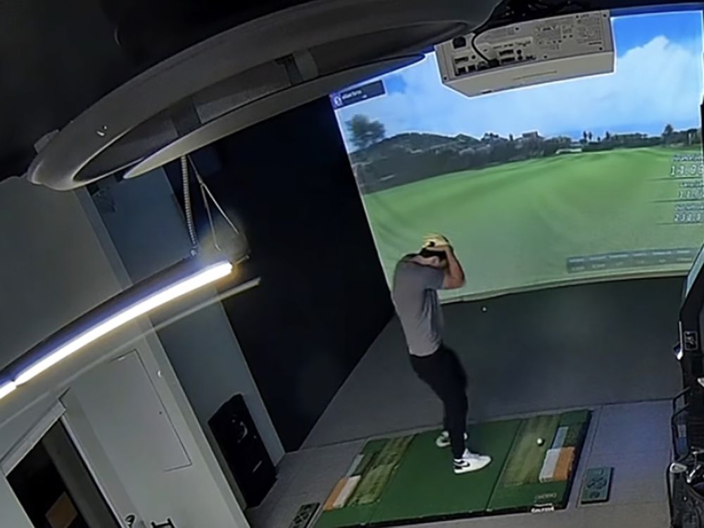 David Bedkowski ducks for cover after the four iron he was using at The Clubhouse Gateway Golf in North Bay got away from him and ended up in the kitchen. Security video of the incident has taken the internet by storm. Screenshot from security video, The Clubhouse Gateway Golf