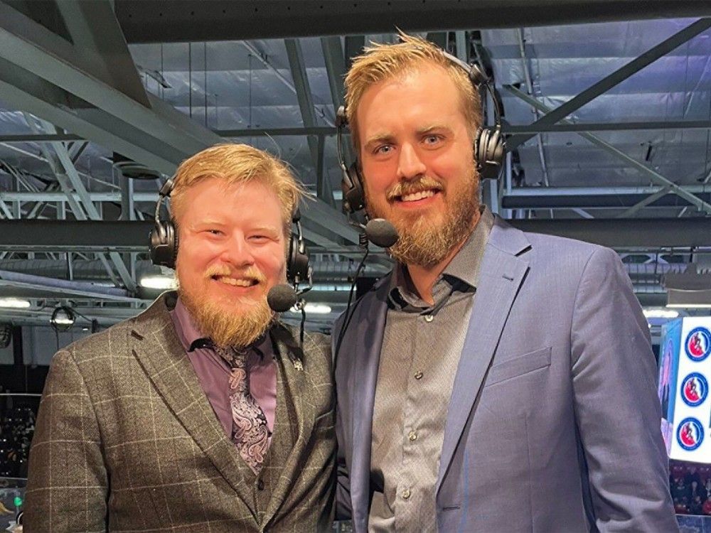 Two announcers at hockey game
