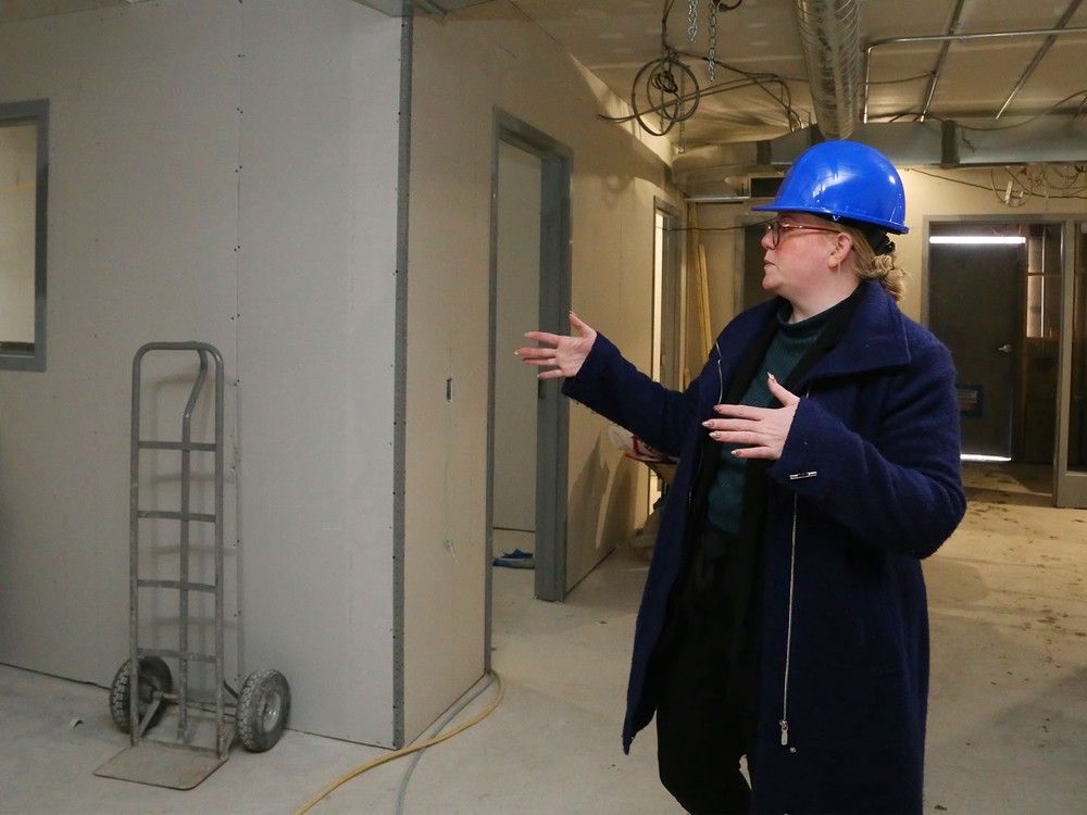 Ashley Vader, director of The Bridge Integrated Care Hub gestures during a tour of the facility's future home Friday, Dec. 12, 2025, in Belleville, Ont. Its first phase - the main floor, part of which is shown here - is to open in early spring.