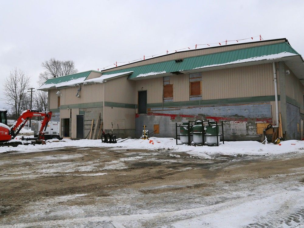 Construction supplies and equipment surround the building at 1 Alhambra Sq. in Belleville, Ont.  Friday, Dec. 12, 2025, in Belleville, Ont. Formerly The Banquet Centre, it is to open this spring as The Bridge Integrated Care Hub's new home.