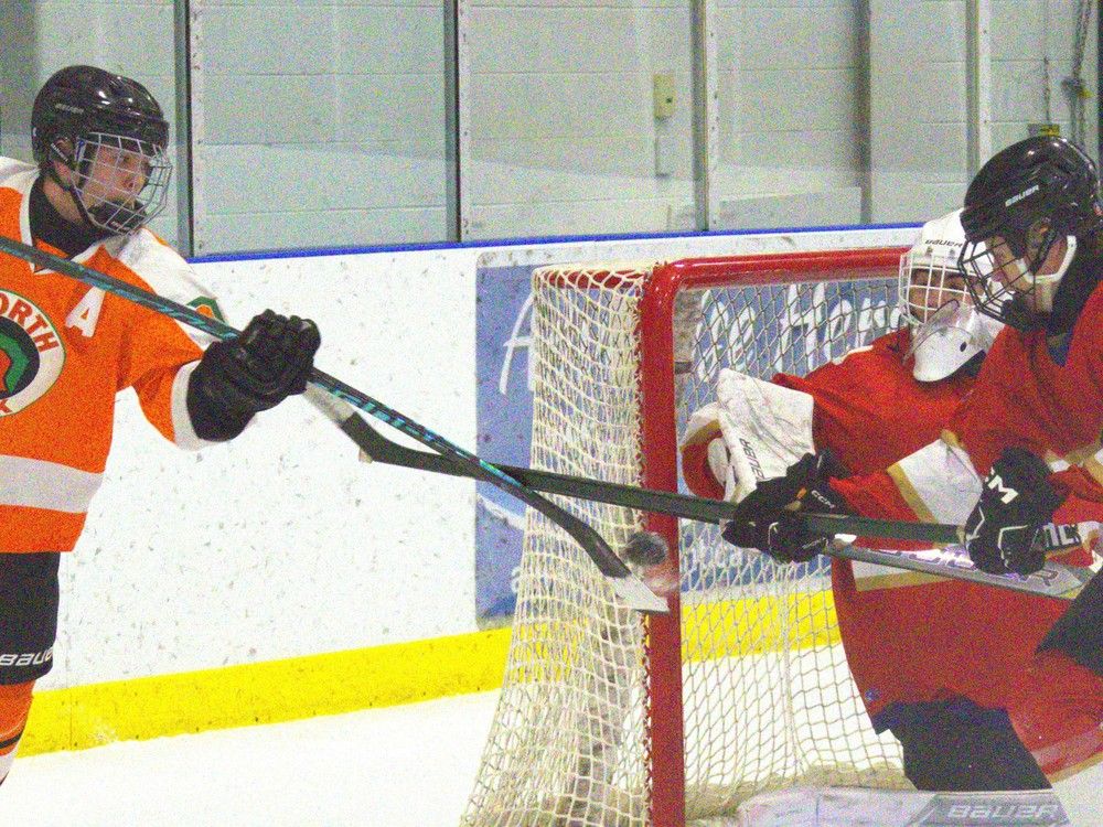 A Michigan attempt by North Park Collegiate's Luc Savoie is thwarted by Paris District High School's Cam Cadwell during an AABHN boys hockey game at Brant Sports Complex on Monday, Dec. 15.