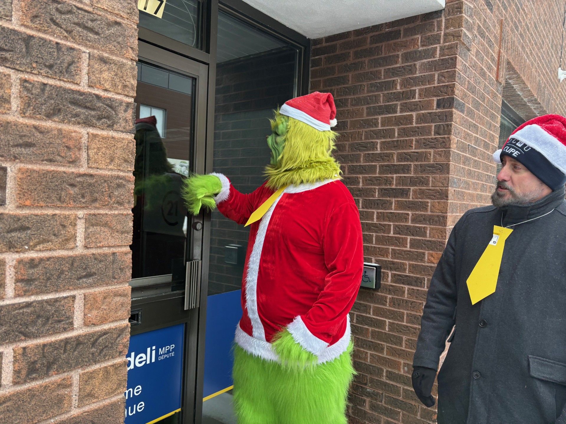 Protest against North Bay hospital job cuts outside Fedeli's office.