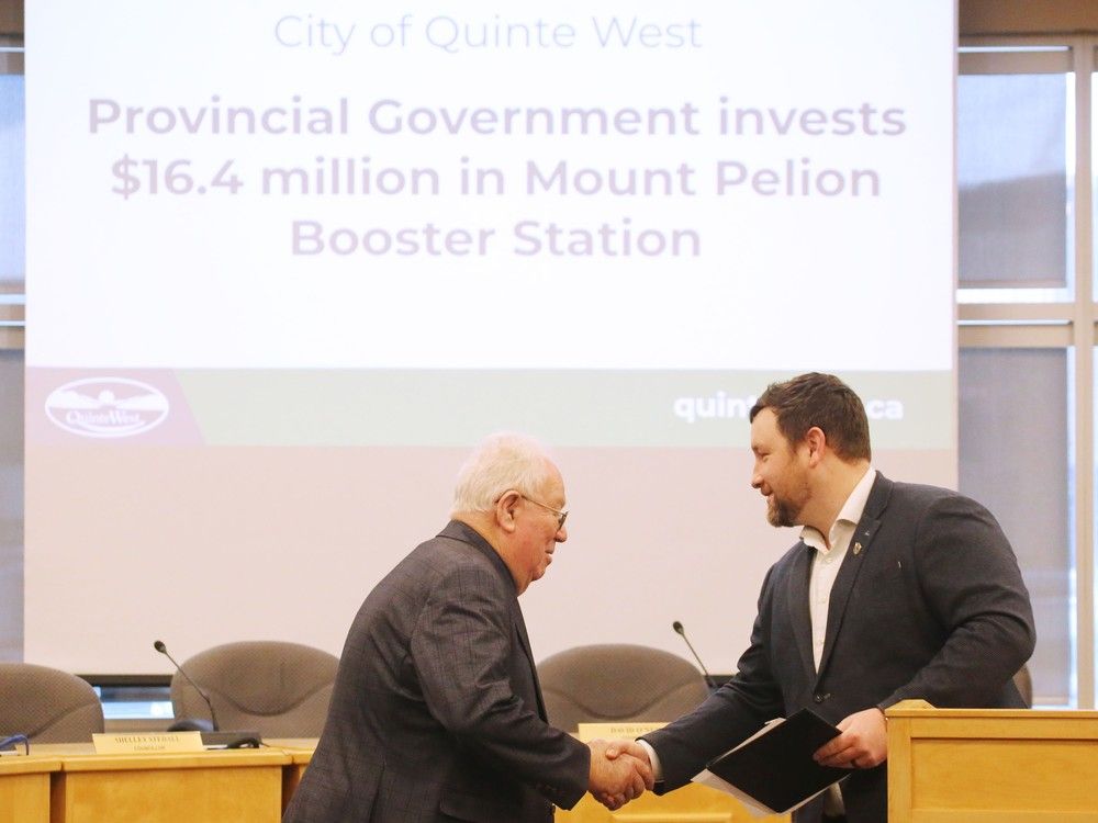 Men in suits seen in profile shaking hands