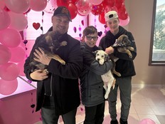 Puppy meet and greet. Three people holding puppes