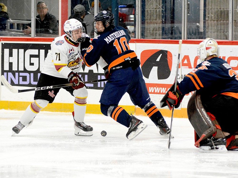 Timmins Rock forward Maxx Hamelin and Thunderbirds defender Gianmarco Mastroianni battle for a loose puck as Soo goalie Ryan Hicks looks on during the first period of Friday night’s NOJHL contest at the McIntyre Arena