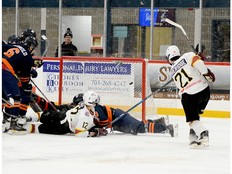 Timmins Rock forward Edan Etheridge lifts the puck up and over Soo Thunderbirds blue-liner Gianmarco Mastroianni and into the net during the first period of Friday night’s NOJHL contest at the McIntyre Arena