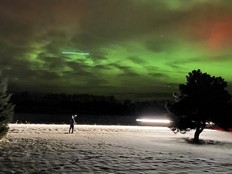 man taking picture of auroras