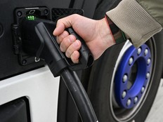 truck driver refuels his electric vehicle
