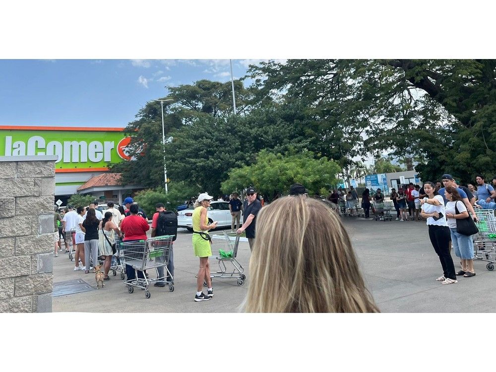  People line up outside one of Puerto Vallarta’s biggest groceries stores on Monday. With many stores still closed, they were worried about having enough provisions.