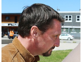 Profile headshot of man with dark hair, goatee, moustache