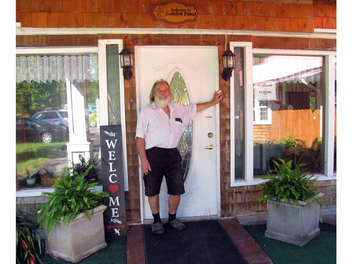 Man standing at doorway of seniors' residential complex