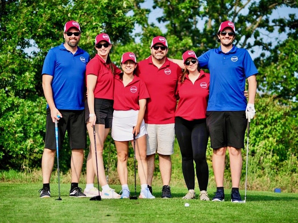 Six golfers standing together